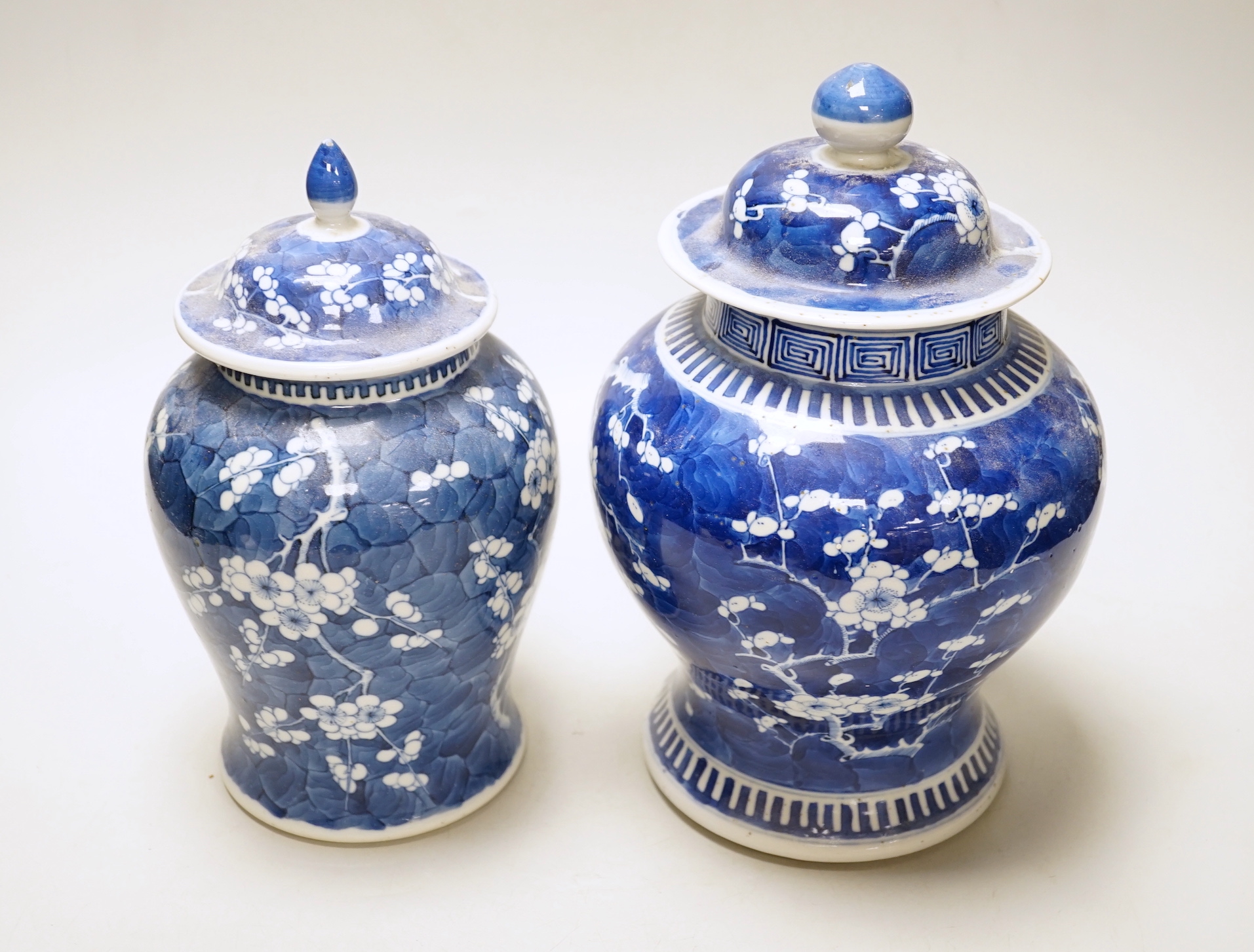 Two late 19th century Chinese blue and white prunus pattern vases, tallest 28cm high (a.f.)